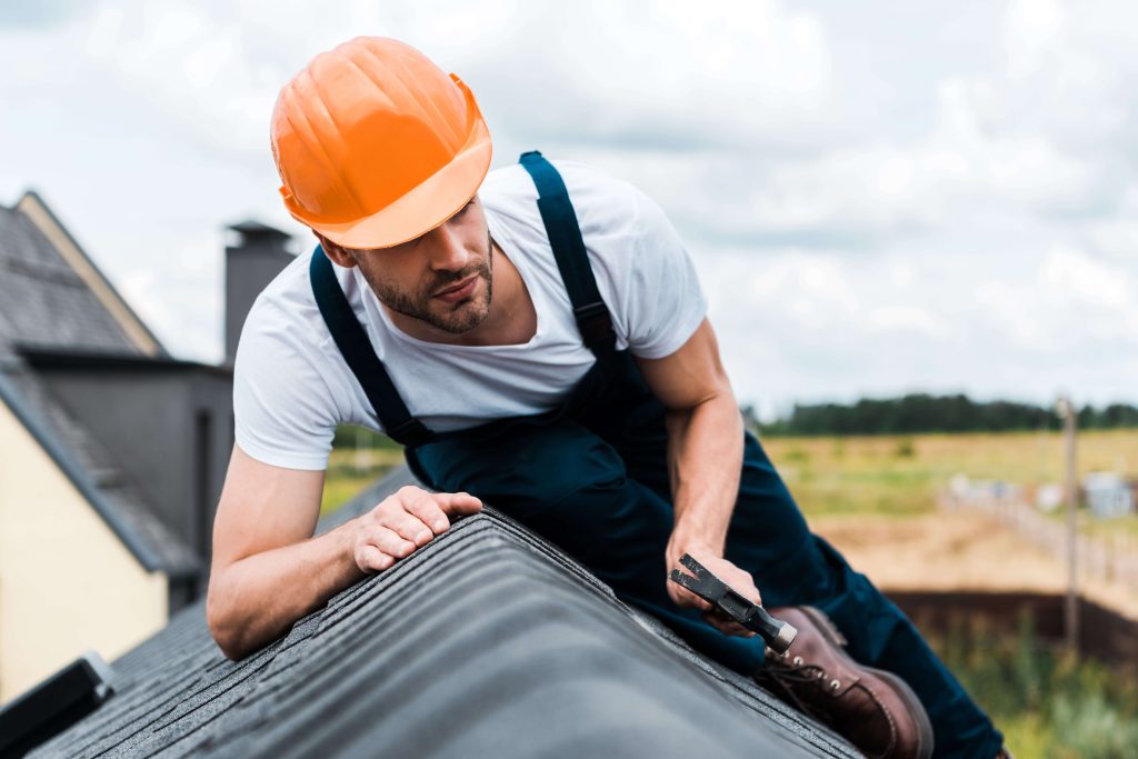 Roofer inspecting a residential roof