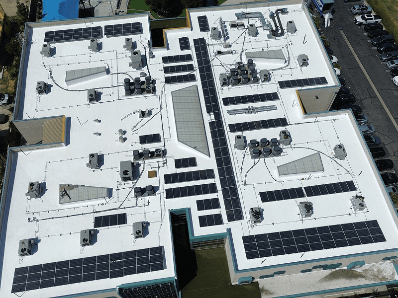 Aerial view of a building with solar panels on the roof.