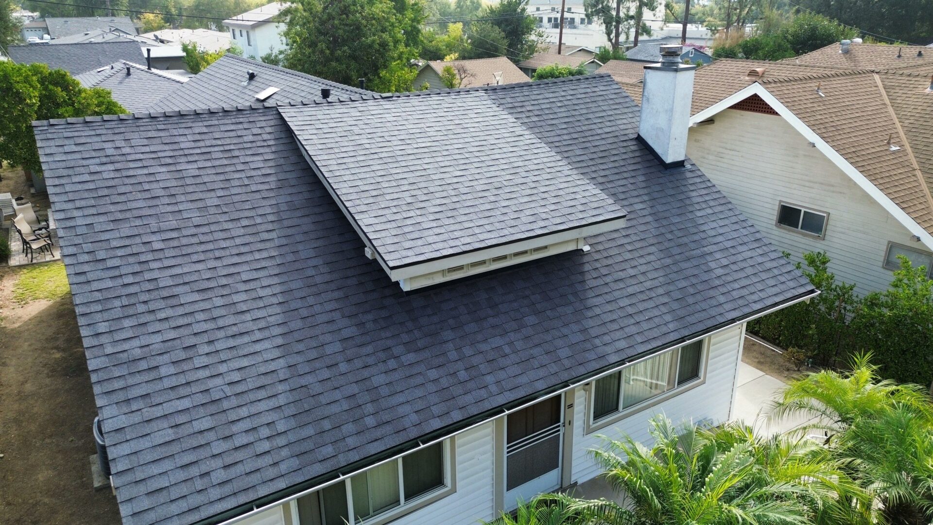 Newly installed dark asphalt shingle roof on a residential home.
