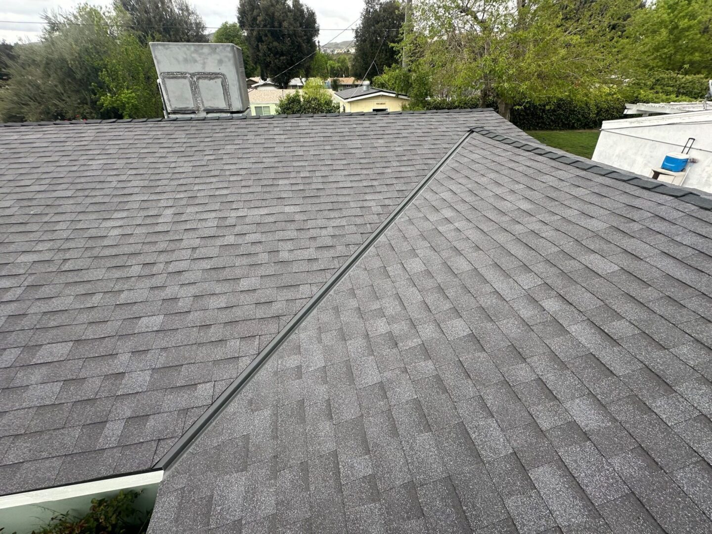 Newly installed gray asphalt shingle roof on a residential home.