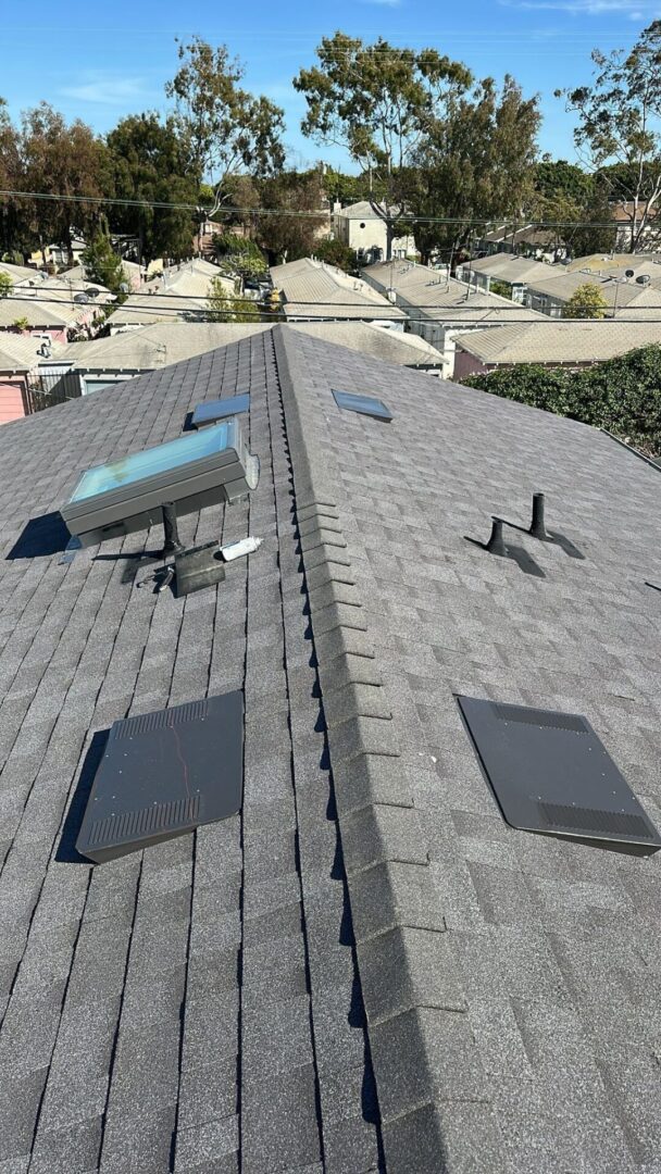 A rooftop with solar panels and vents under bright sunlight.
