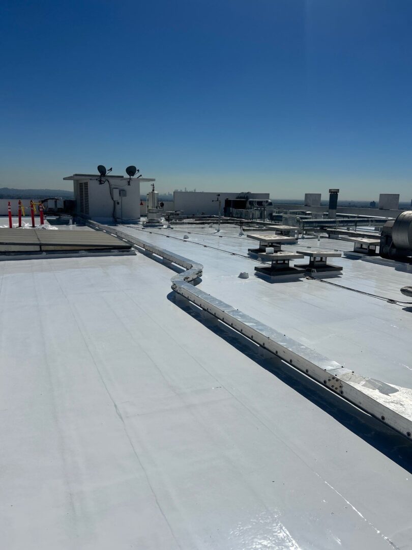 Wide rooftop view of an airport terminal with planes and vehicles.