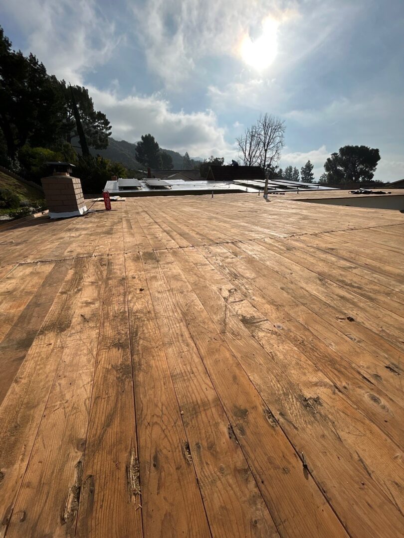 Spacious wooden deck under a partly cloudy sky.