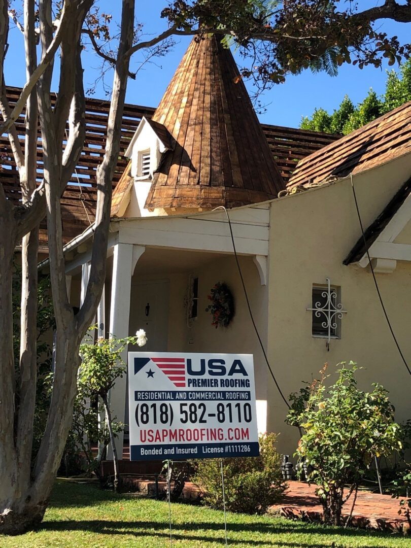 Charming house with a unique turret and a real estate sign for USA Home Realty.