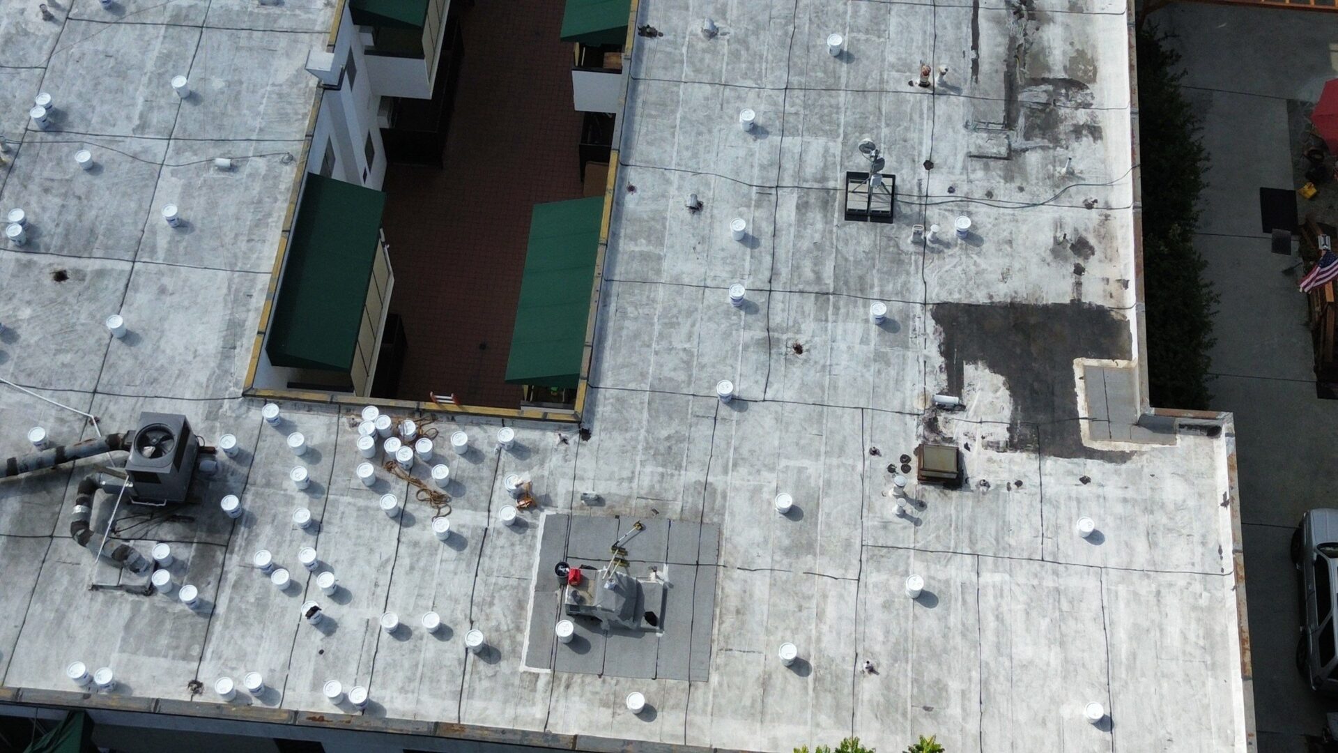 A rooftop with various vents and equipment scattered across its surface.