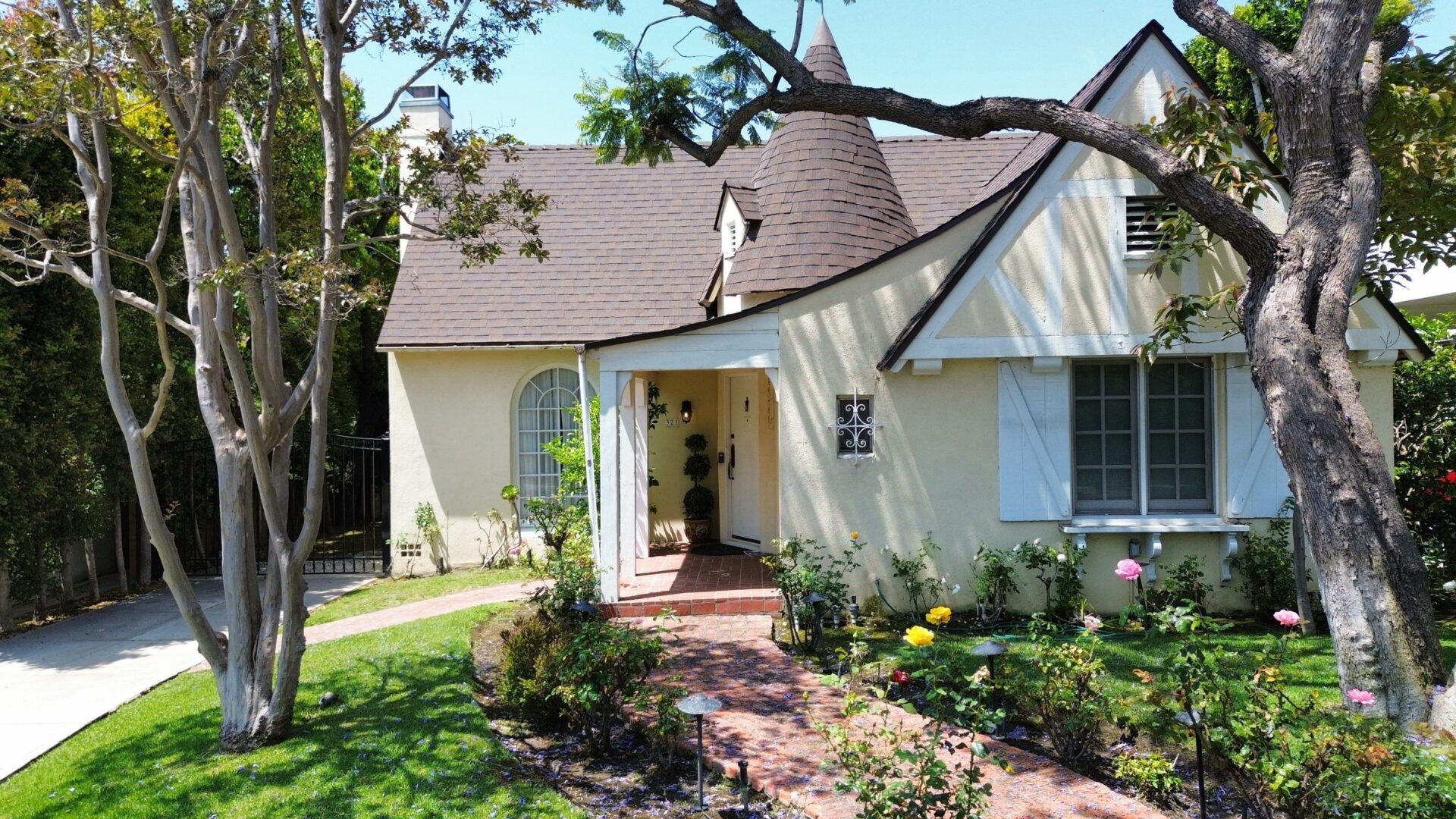 Charming cottage with a cozy porch and lush garden.