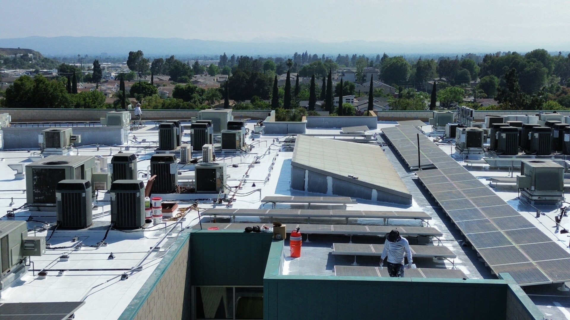 Rooftop with HVAC units and clear sky in the background.