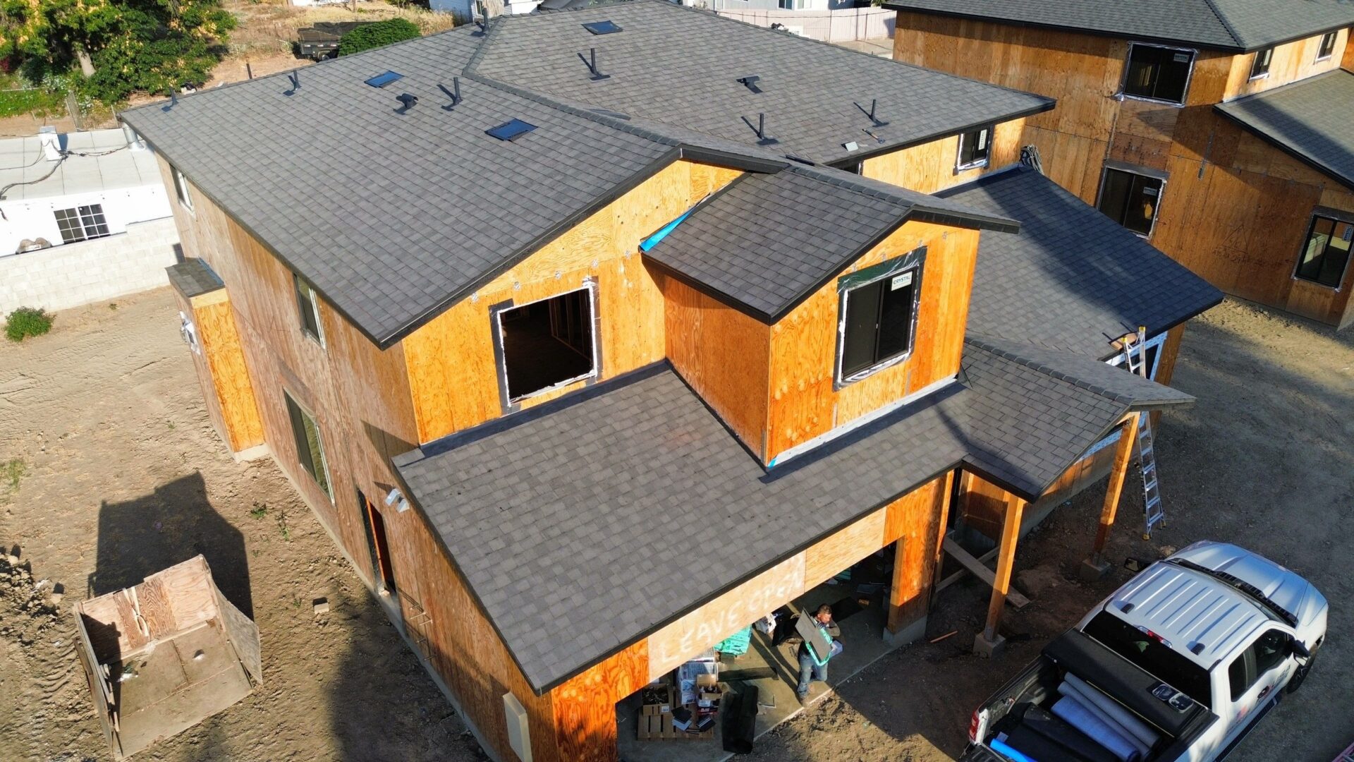 Modern wooden house with flat and sloped roofs.