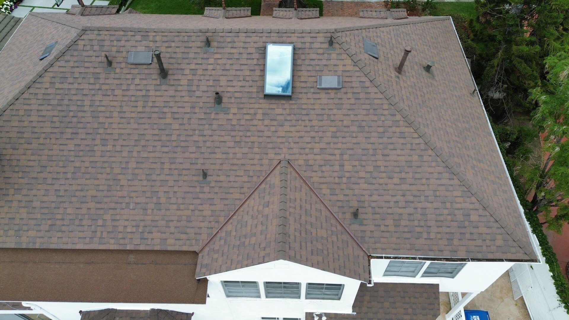 A residential rooftop with a skylight and vents.