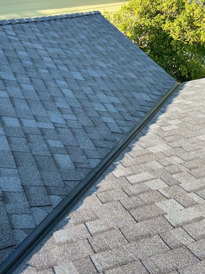 Comparison of two types of roof shingles on adjacent roofs.