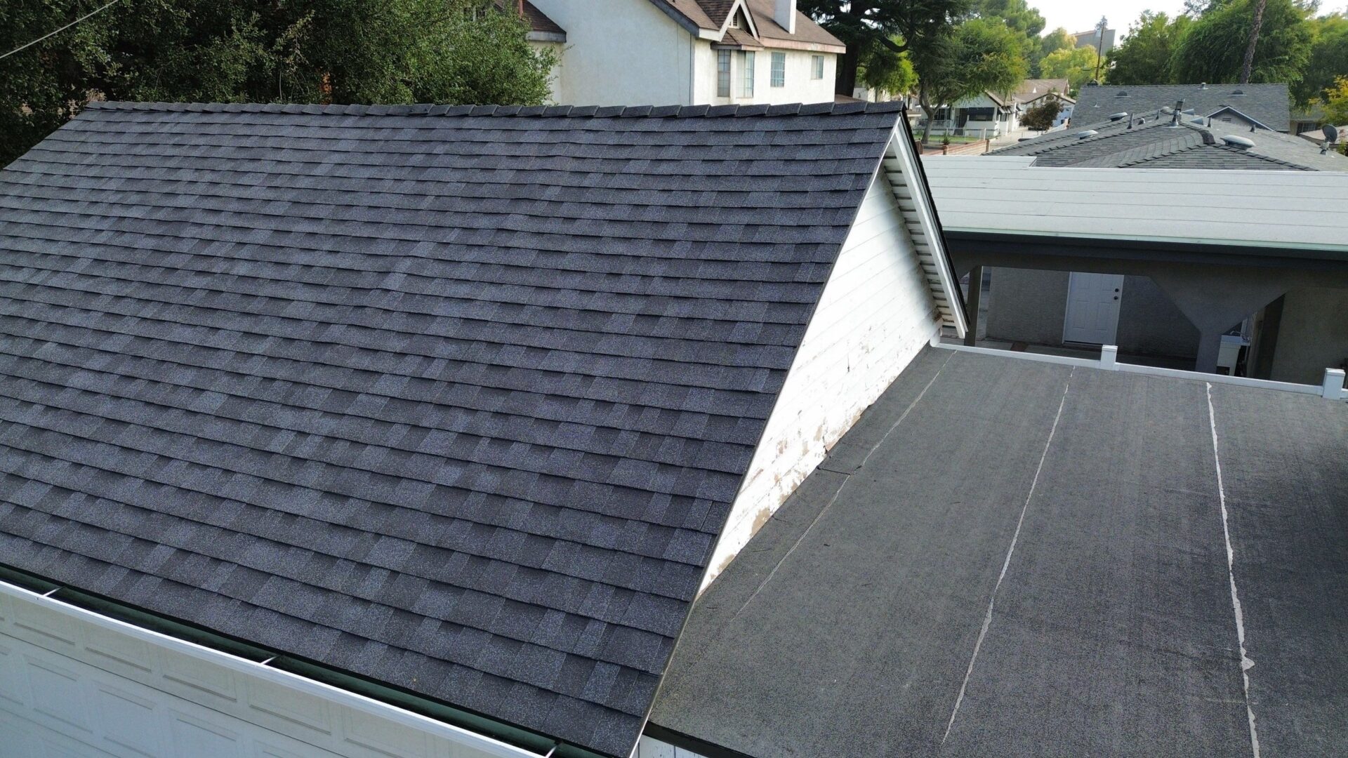 Newly installed dark gray asphalt shingle roof on a residential house.