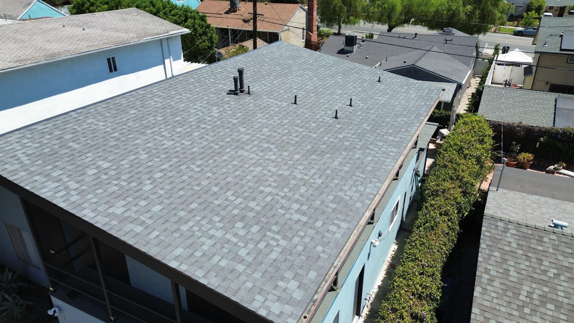 Newly installed gray shingle roof on a residential house.
