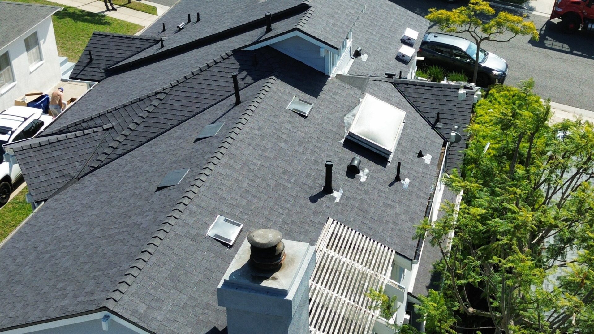 Aerial view of a modern house roof with various vents and skylights.