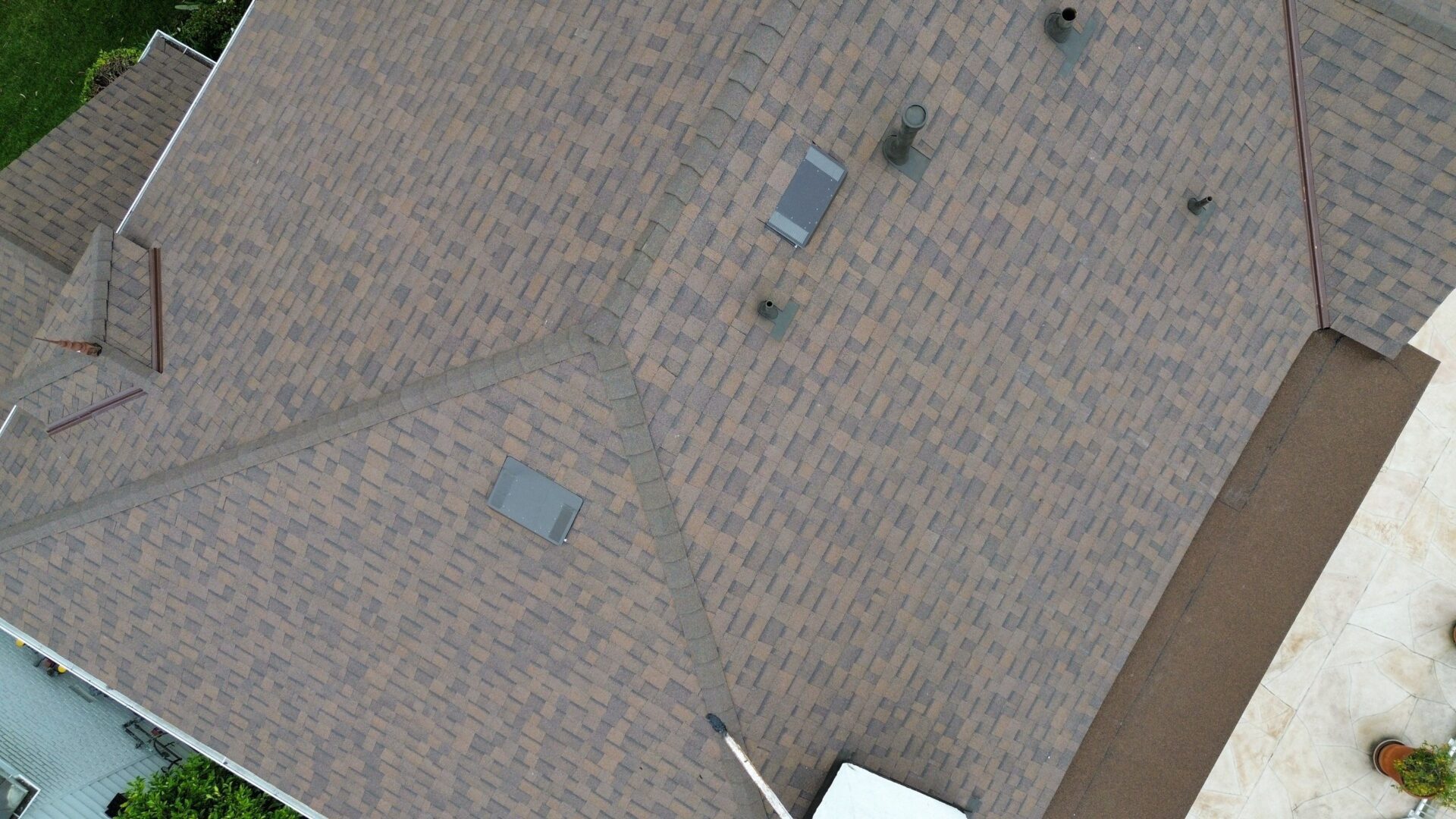 A textured brown surface with small scattered objects, including a phone and a white item.