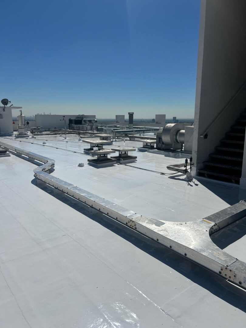 Airport jet bridges and tarmac under clear blue sky.