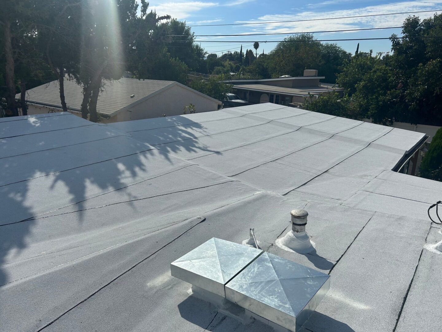 Flat rooftop with ventilation vents and a clear sky.