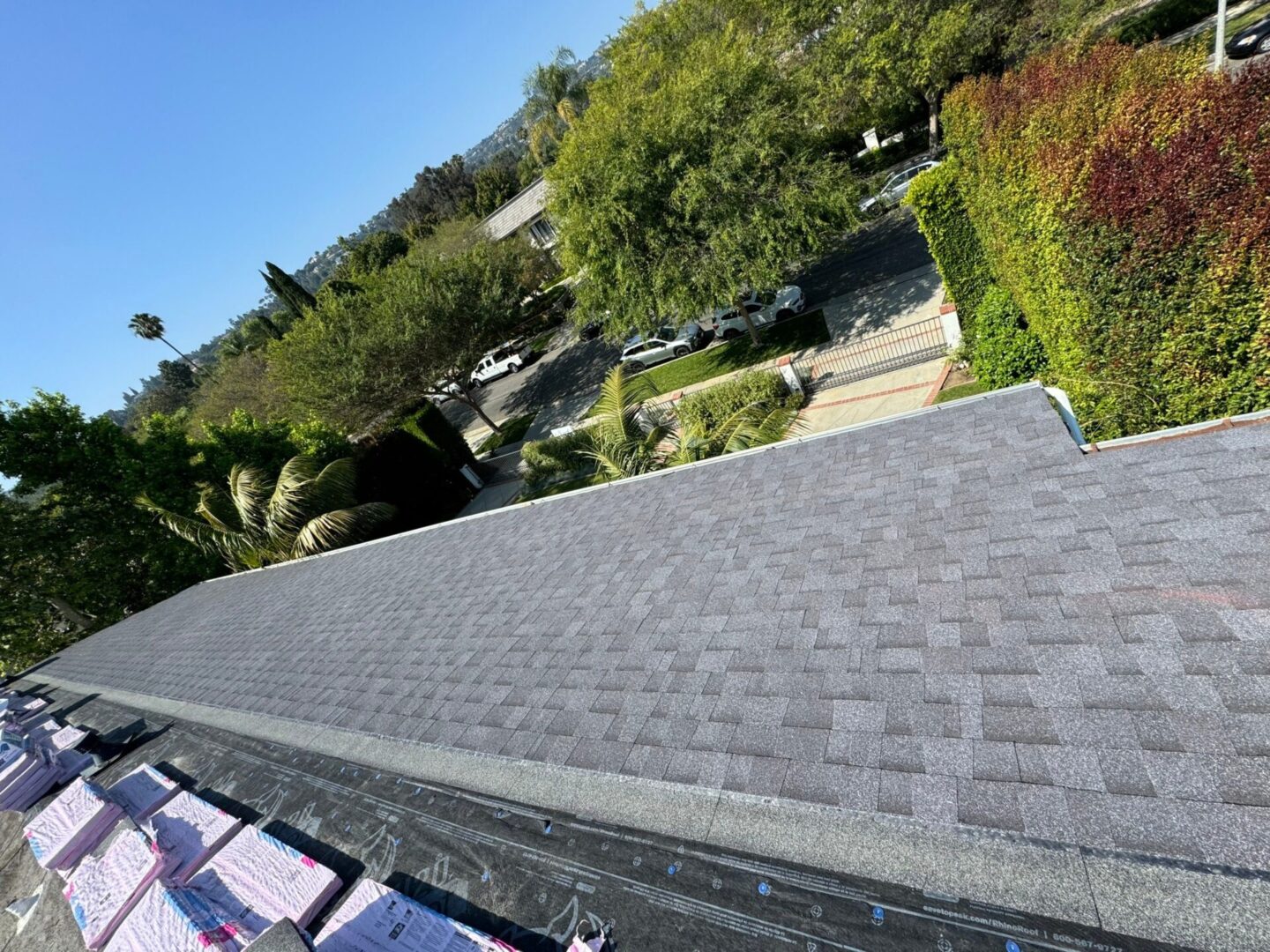 Newly installed gray asphalt shingle roof on a residential house.