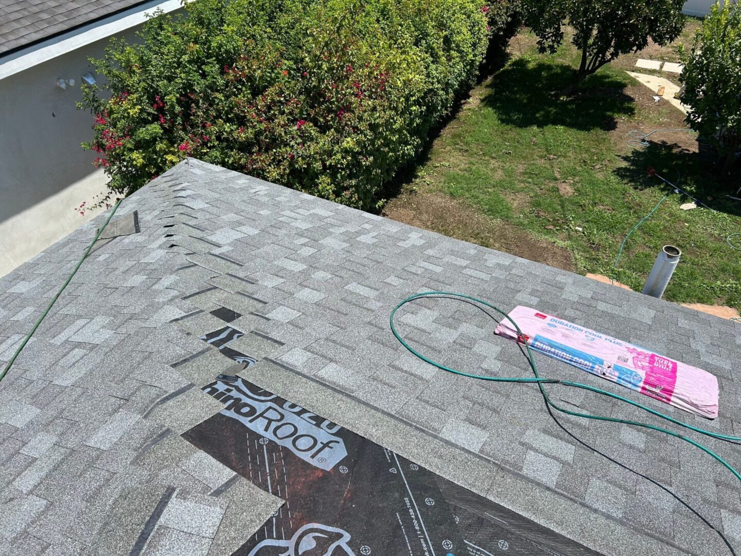 Roof with gray shingles and Verizon roofing material visible.