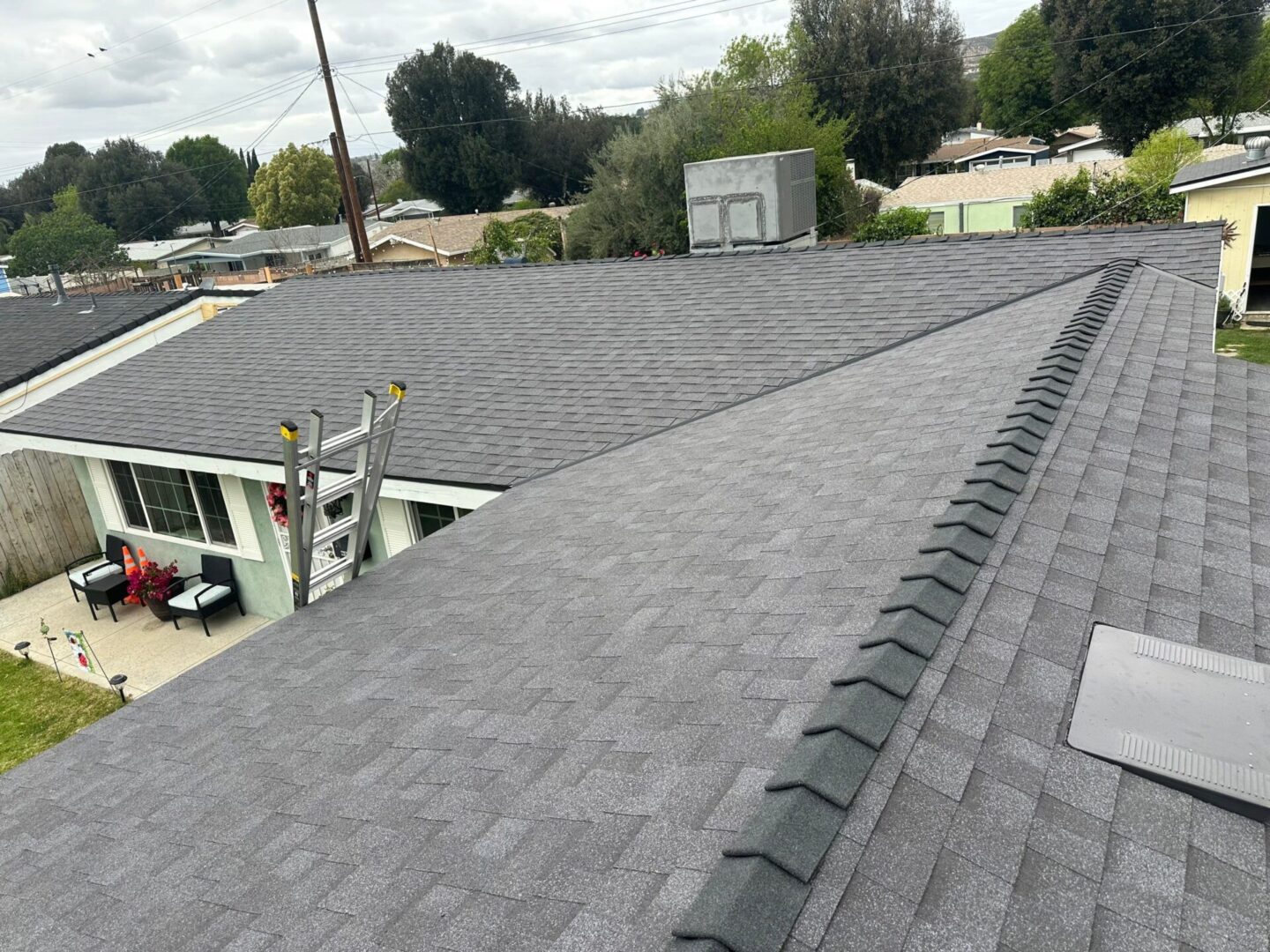 Newly installed gray asphalt shingle roof on a residential house.
