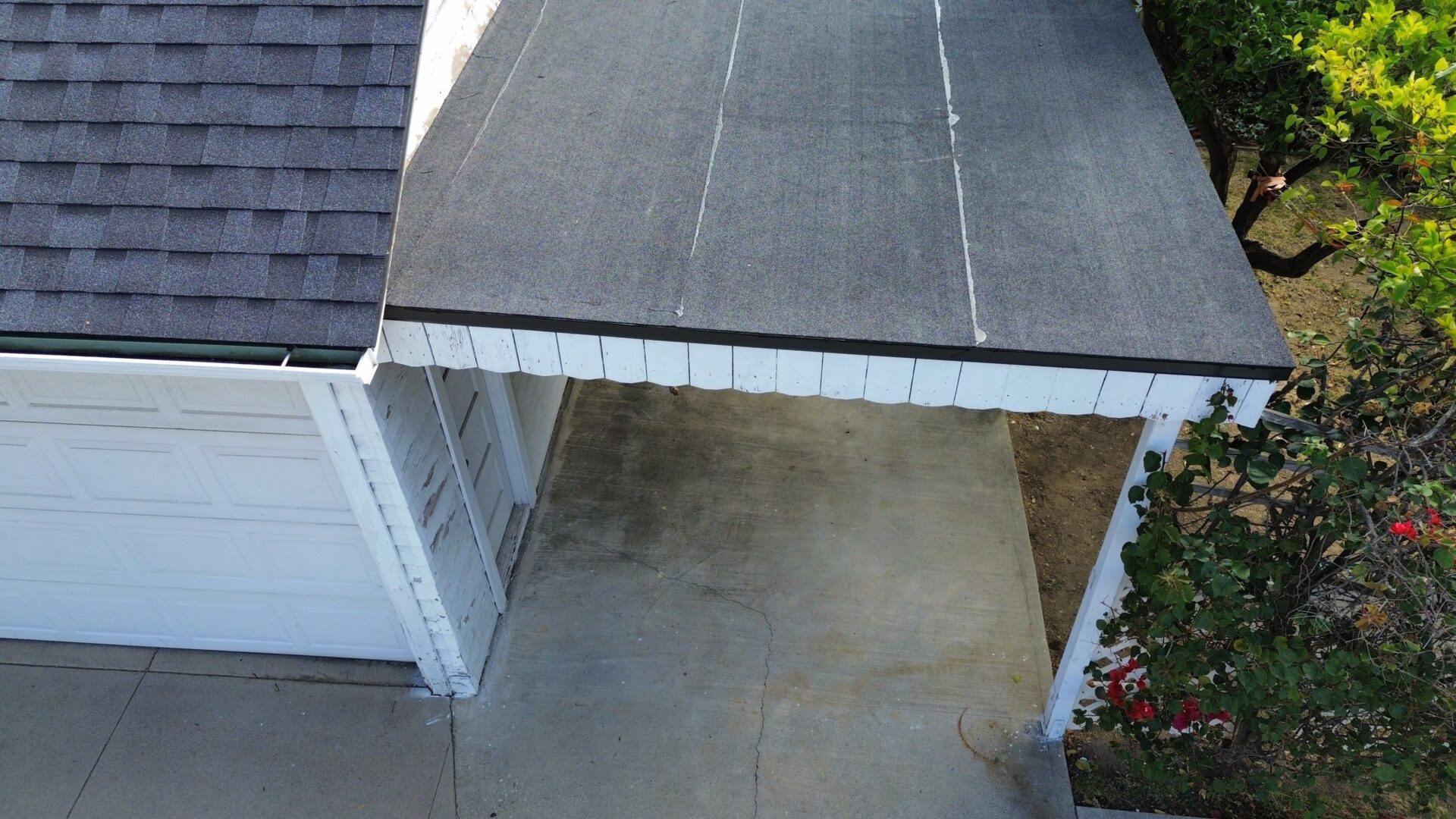 Empty carport with concrete floor and roof.