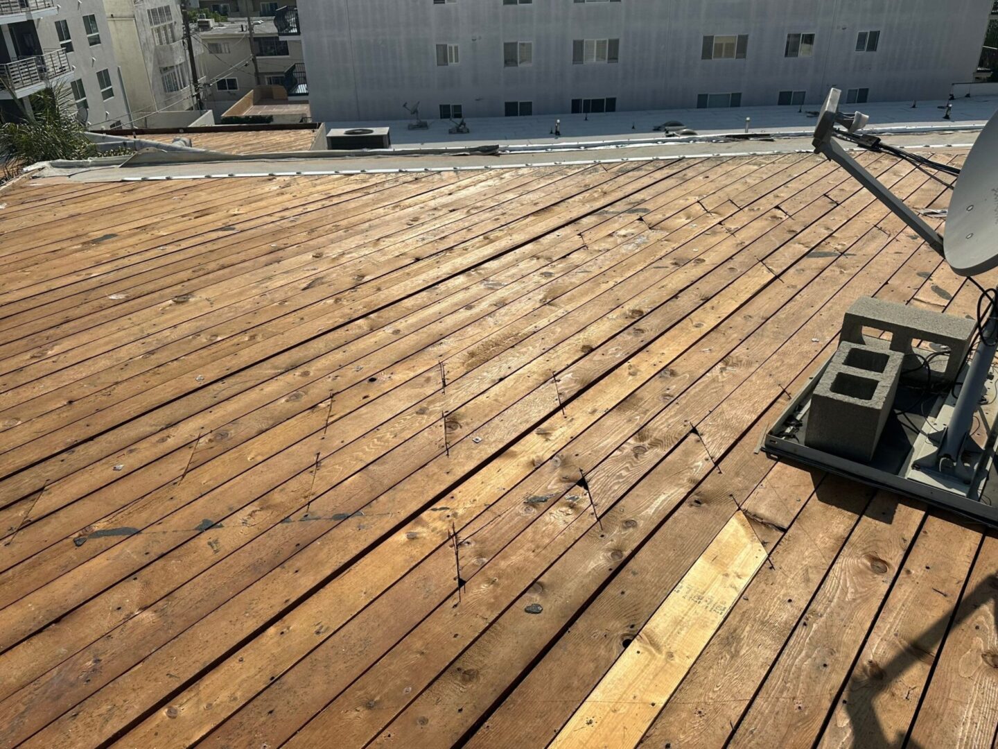 Wooden decking being installed under daylight.