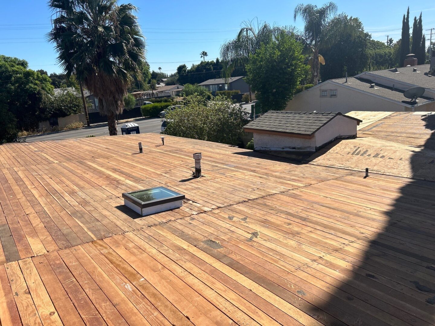 Newly installed wooden roof decking on a sunny day.