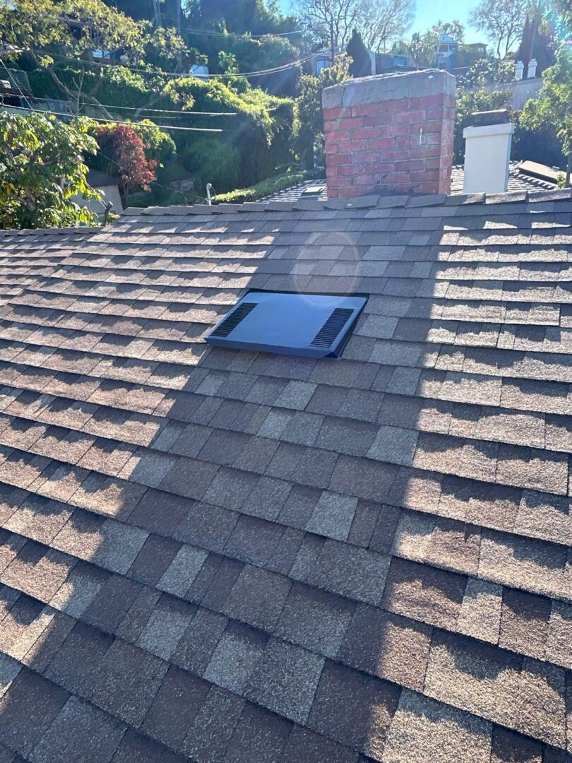 A rooftop with a newly installed solar panel under sunlight.
