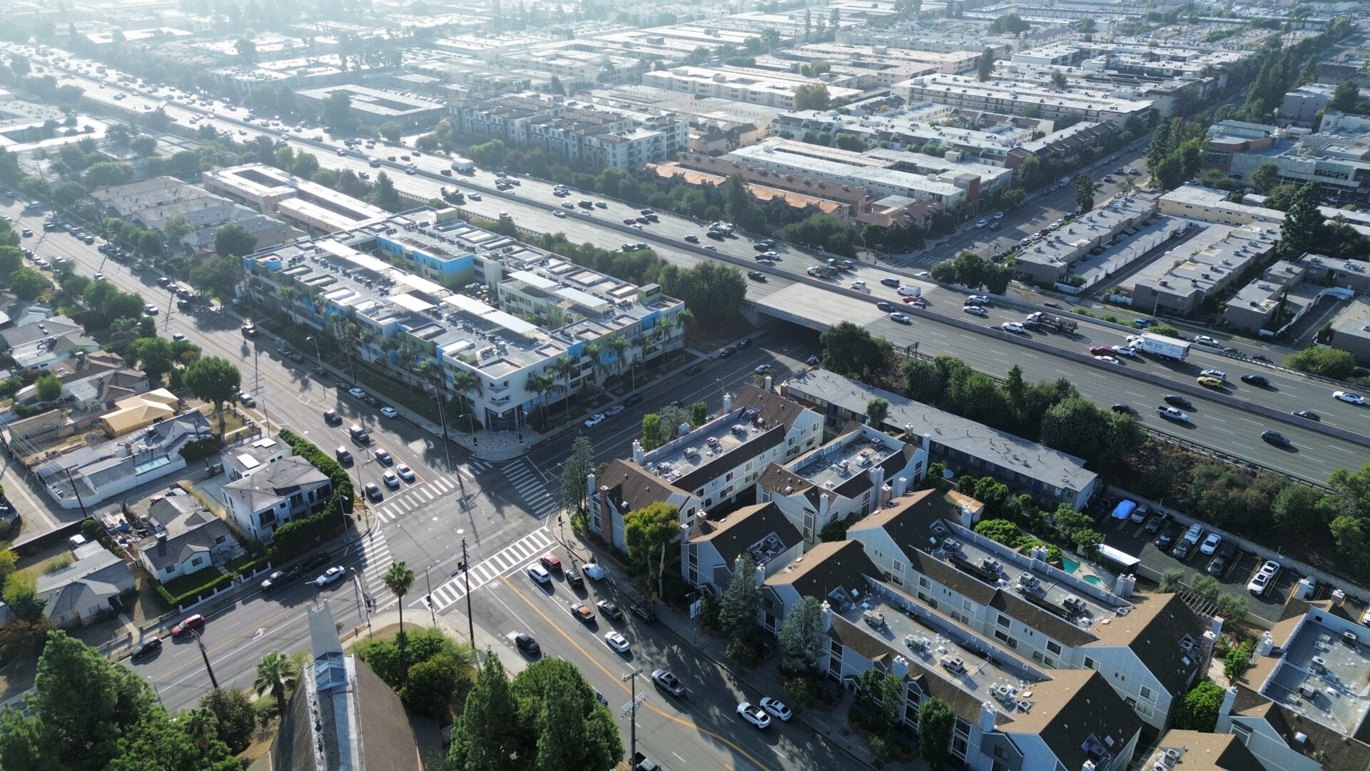 Aerial view of a busy urban intersection with industrial buildings around.
