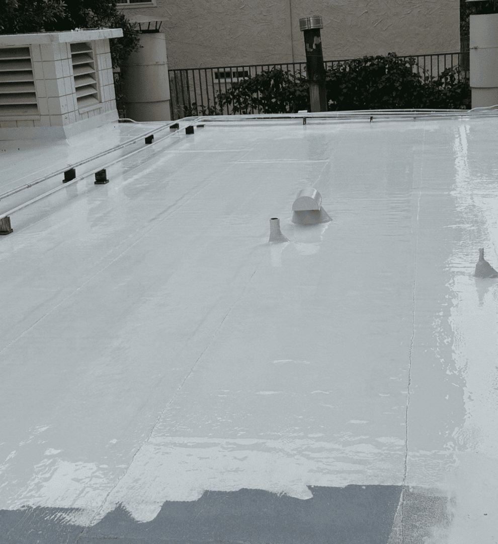 Workers applying waterproof coating on a rooftop.