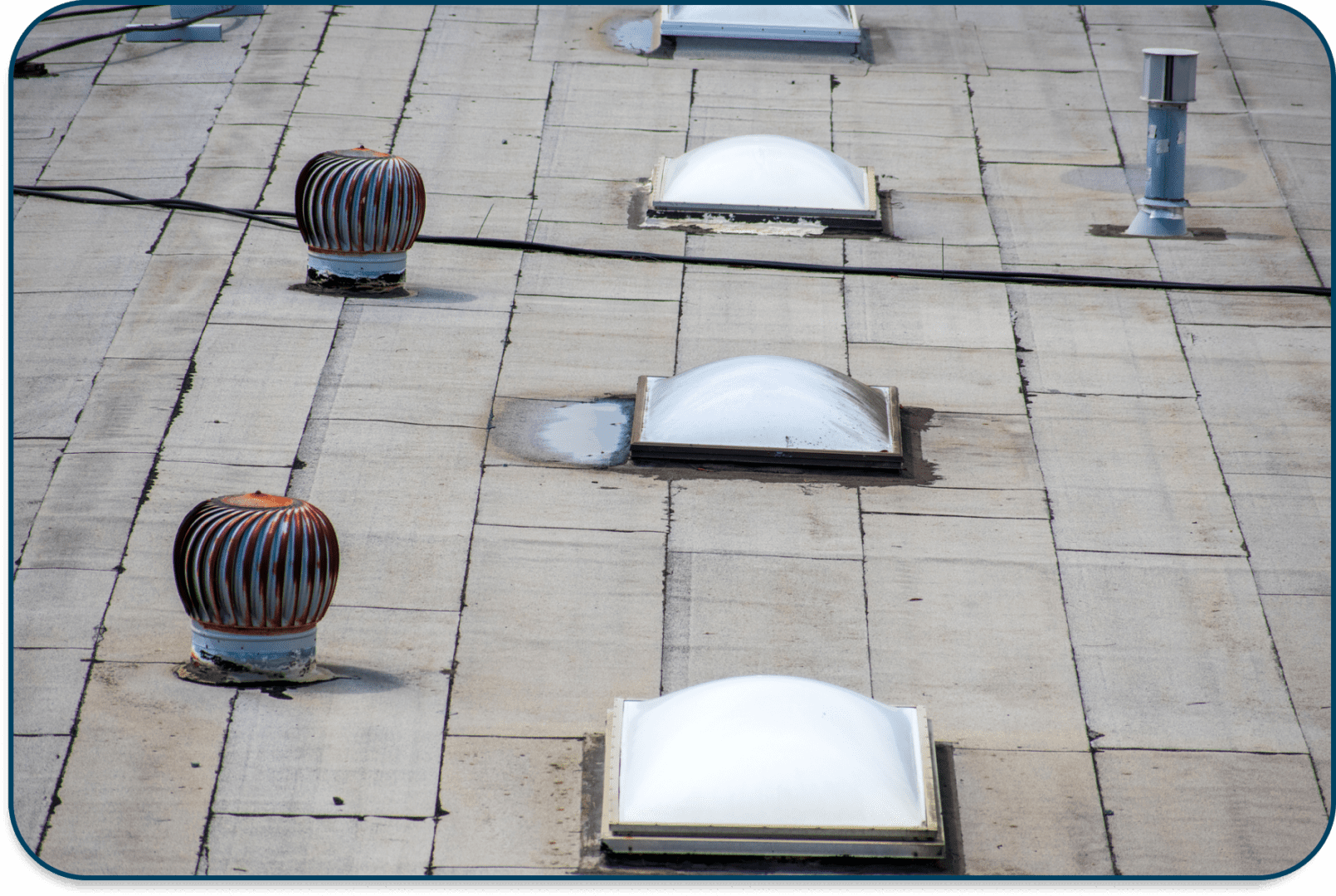 Roof vents and skylights on a flat rooftop.
