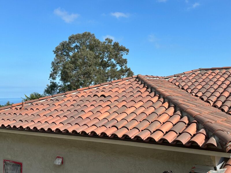 Terracotta Mediterranean roof tiles under blue sky